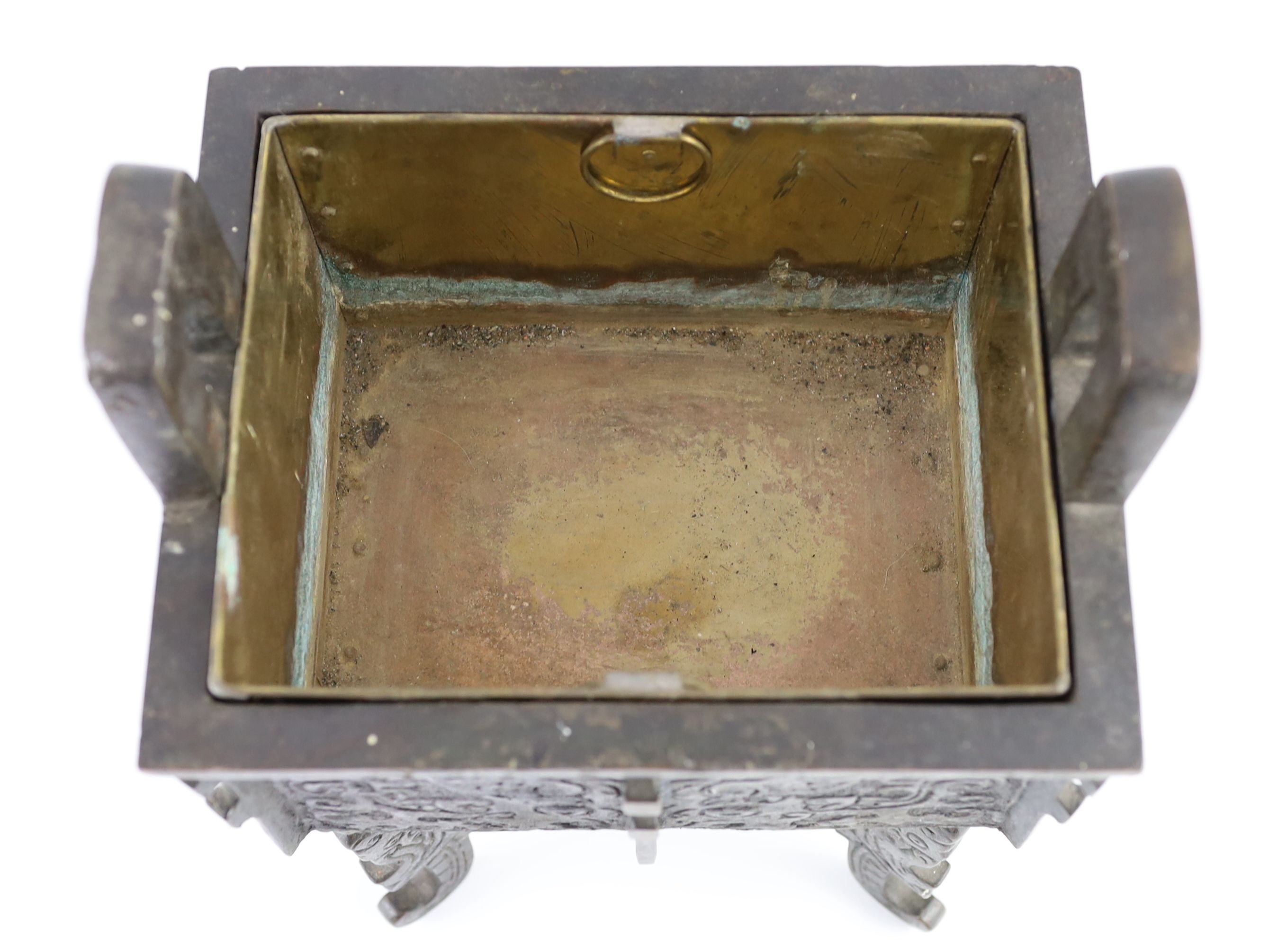 A Chinese archaistic bronze rectangular censer, fangding, 17th/18th century 34cm high, 24cm wide, 20cm depth later liner and repairs to legs